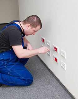 Electrician installing outlets