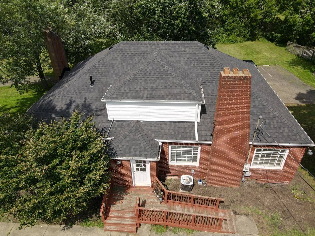 An aerial view of a house with a black roof