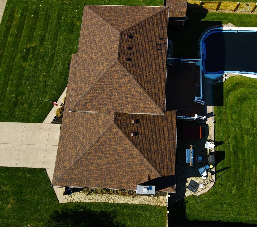 An aerial view of a house with a black roof