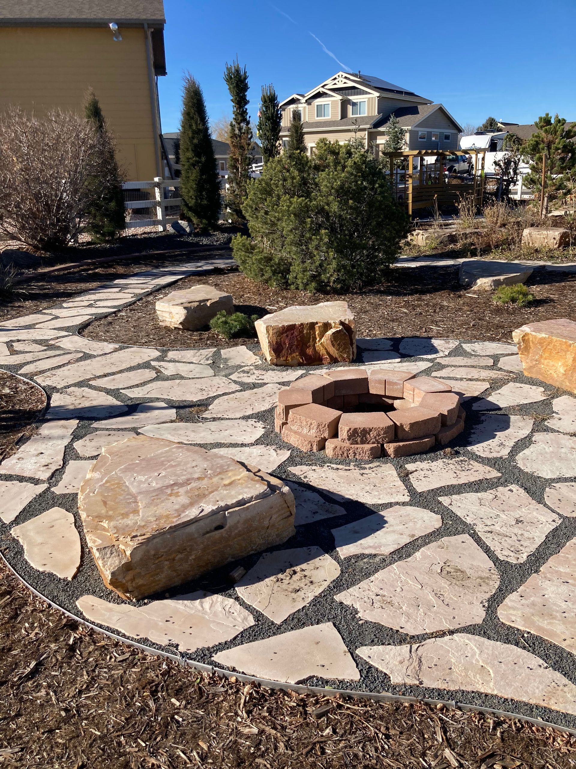 There is a fire pit in the middle of the patio.