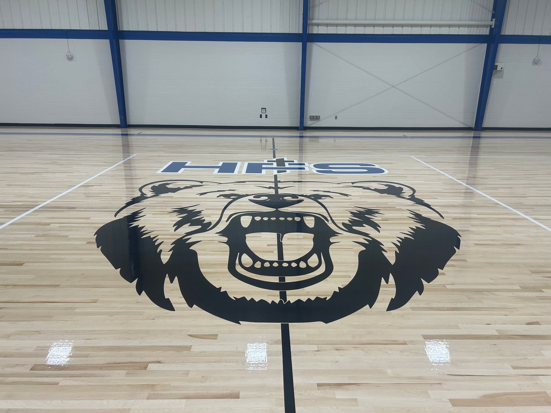 A basketball court with a bear logo on it