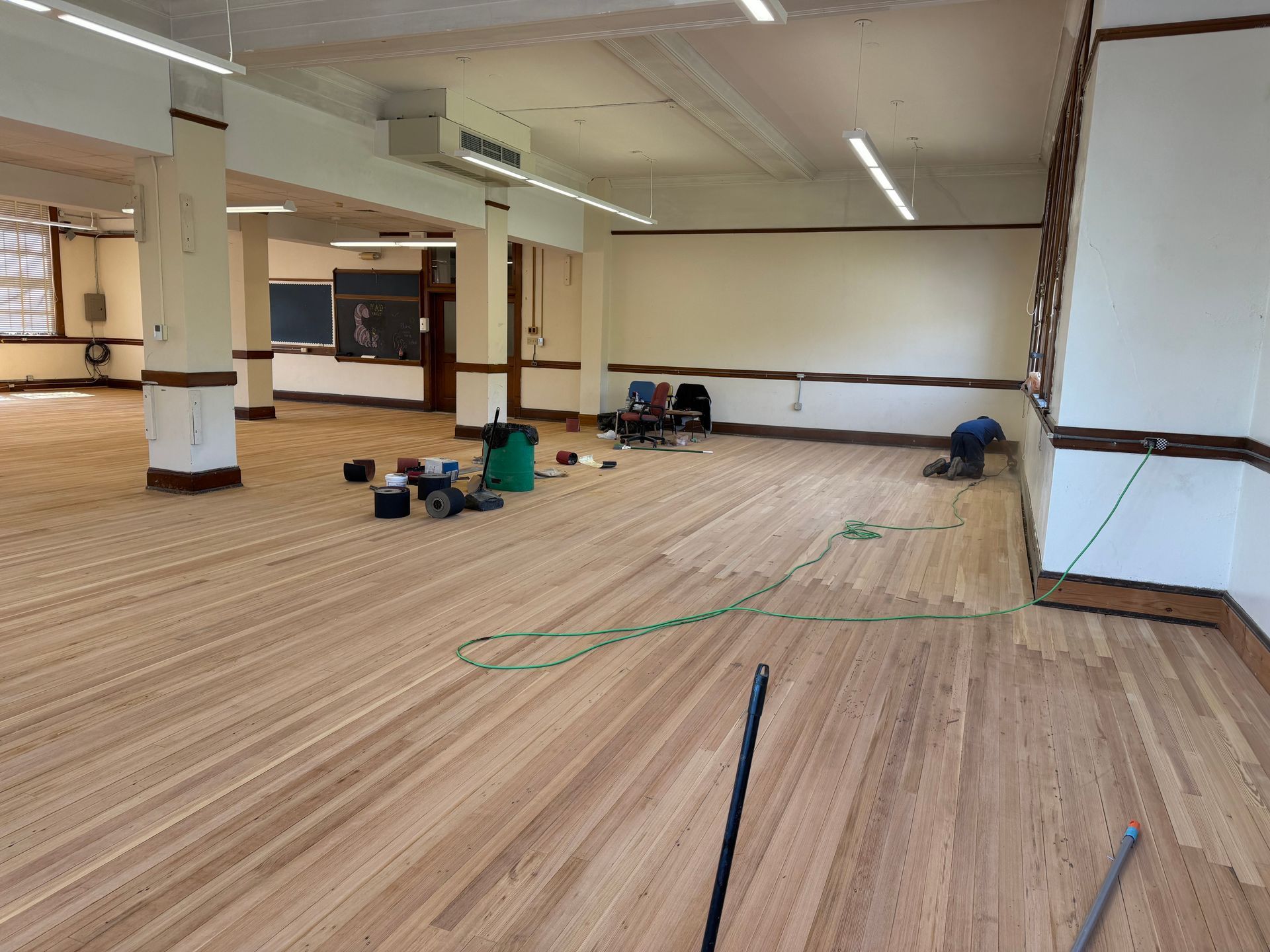 A large room with a wooden floor and white walls.