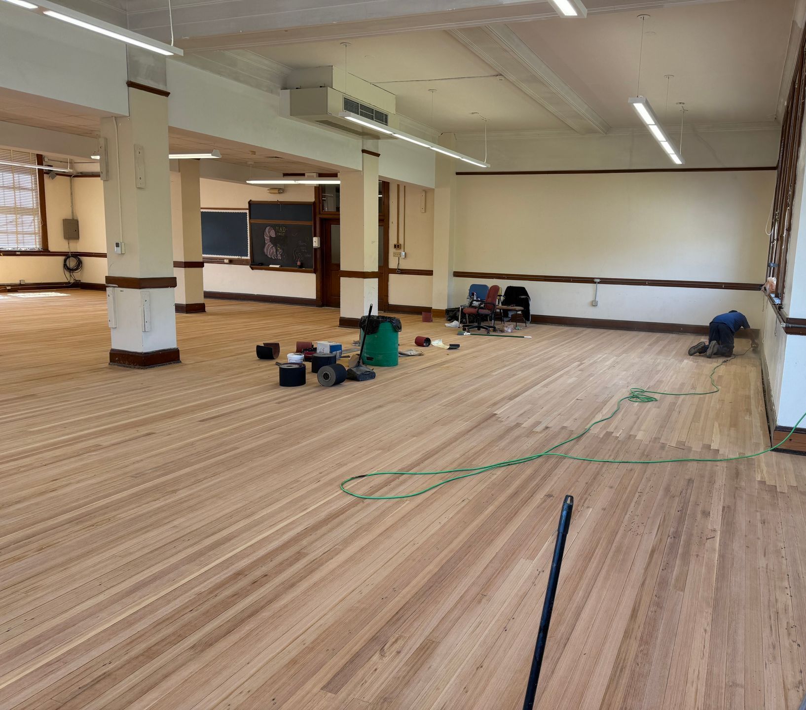 A large room with a wooden floor and white walls.