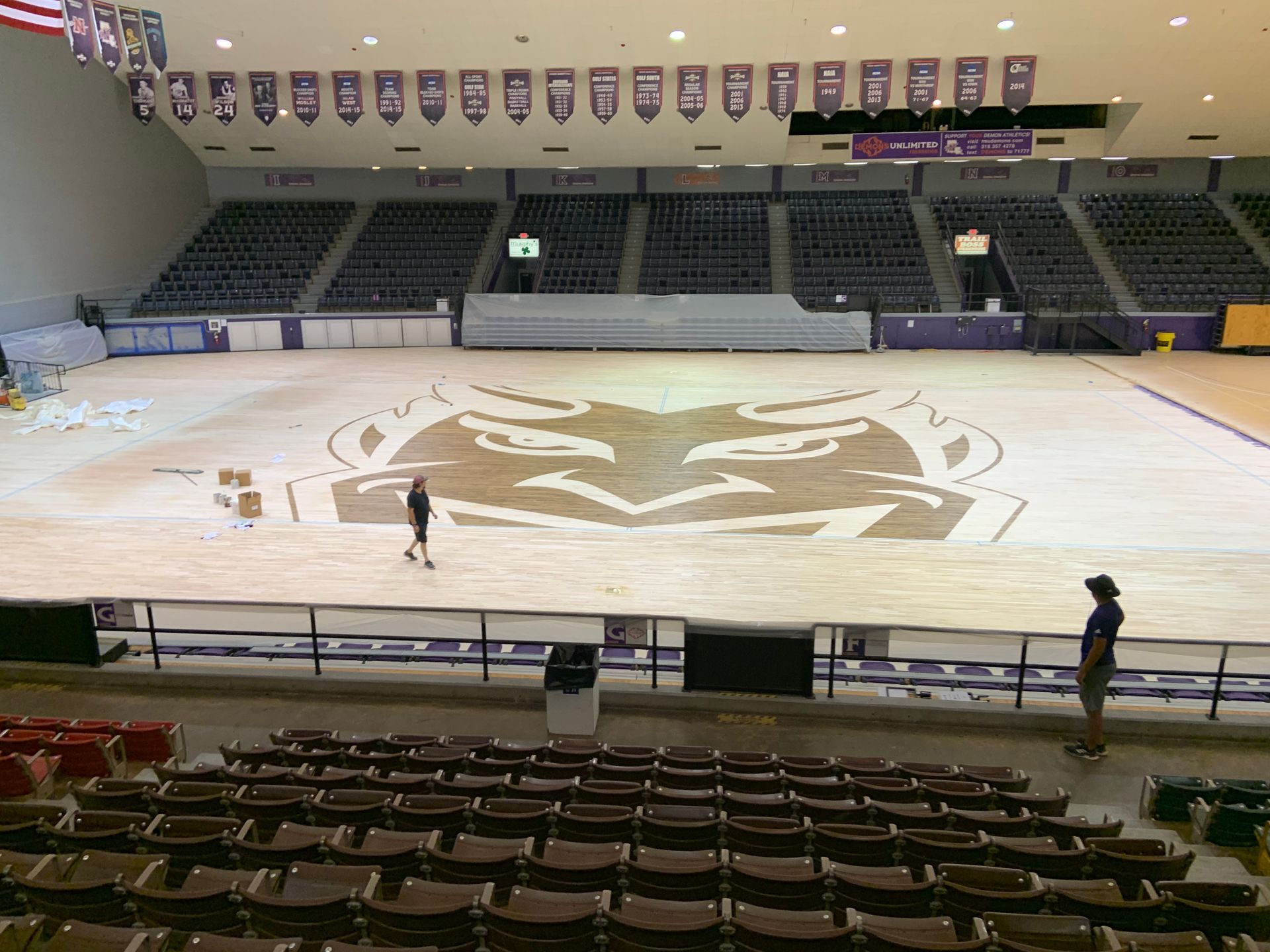 An empty stadium with a tiger logo on the floor