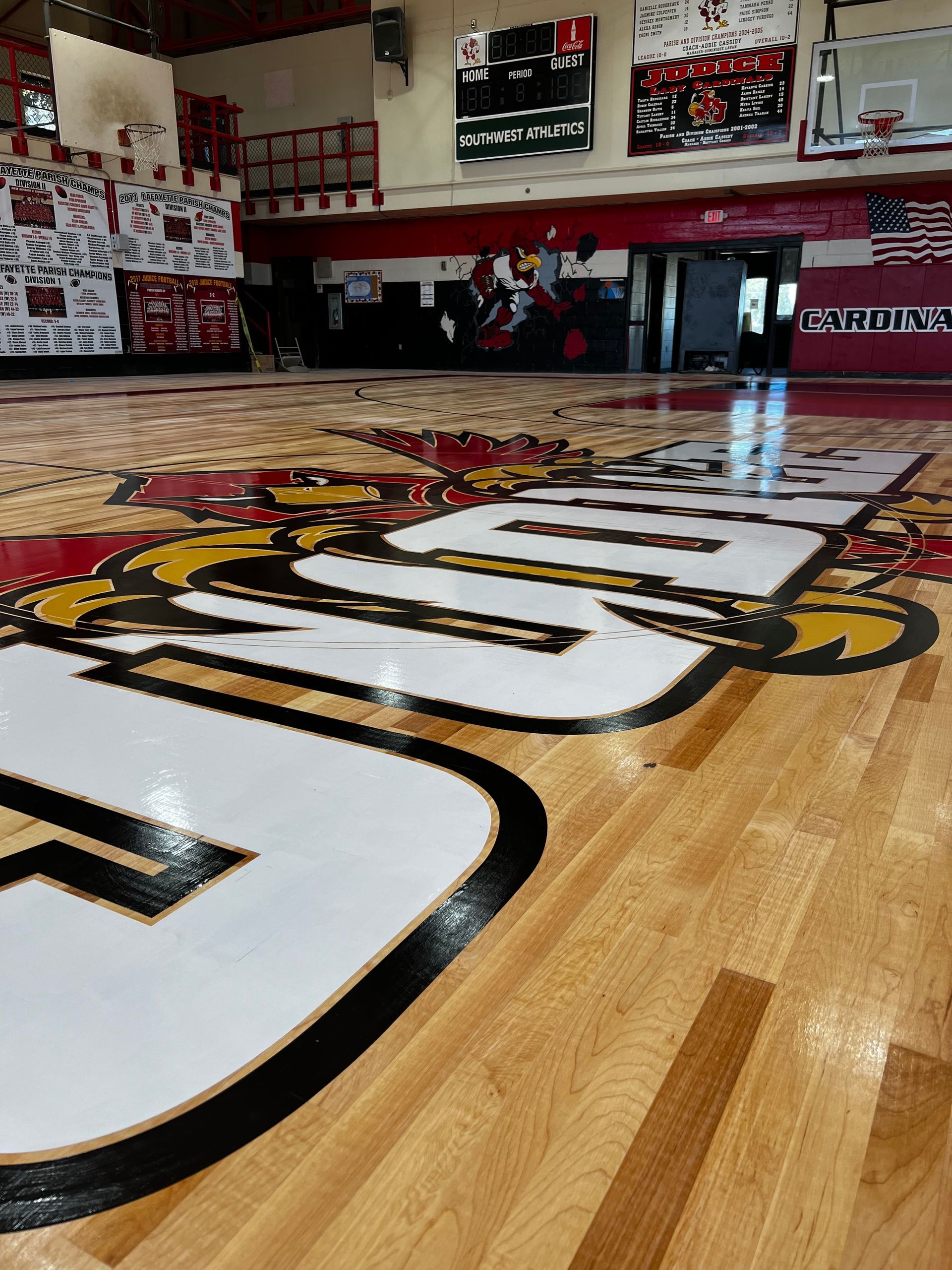 A basketball court with a large g on the floor