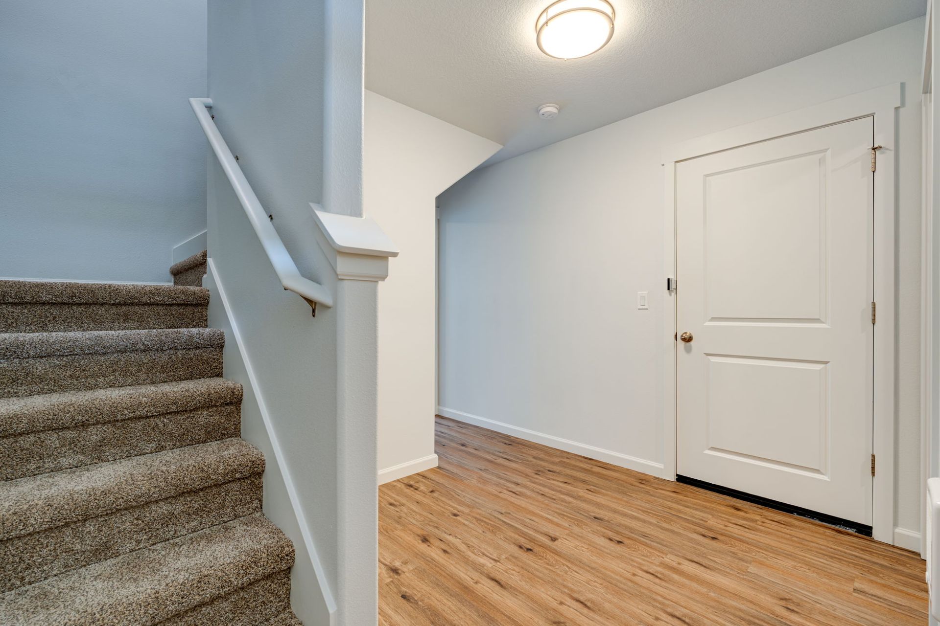Entryway with view of stairs to the left and door to garage at the right