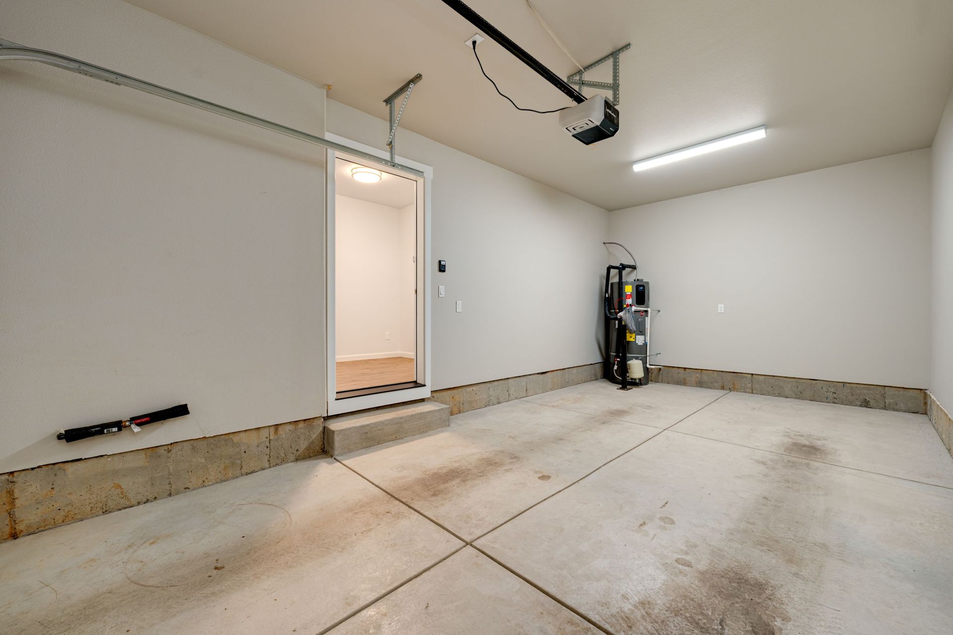 View from garage to entryway with water heater to the right