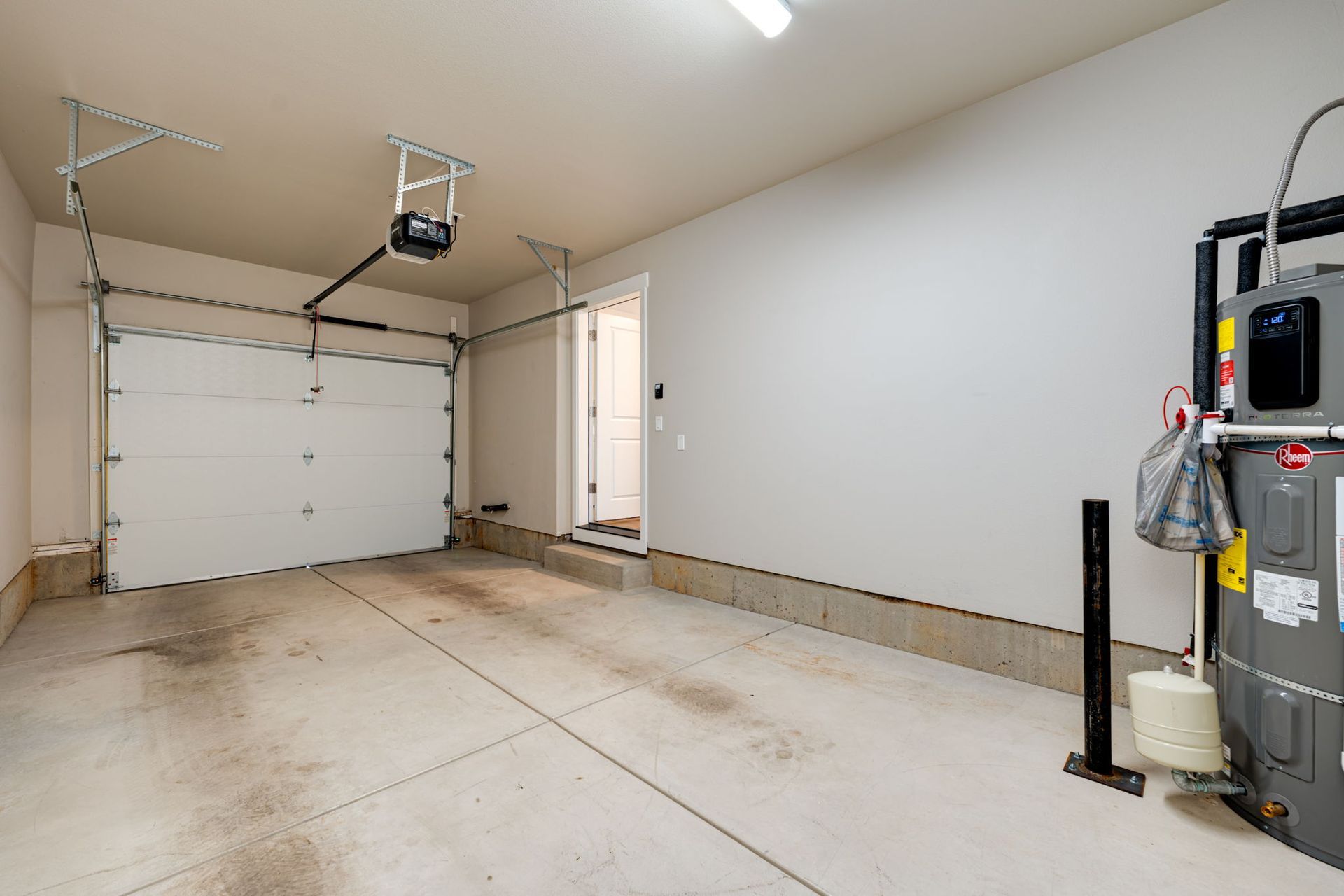 View inside garage facing closed automatic door