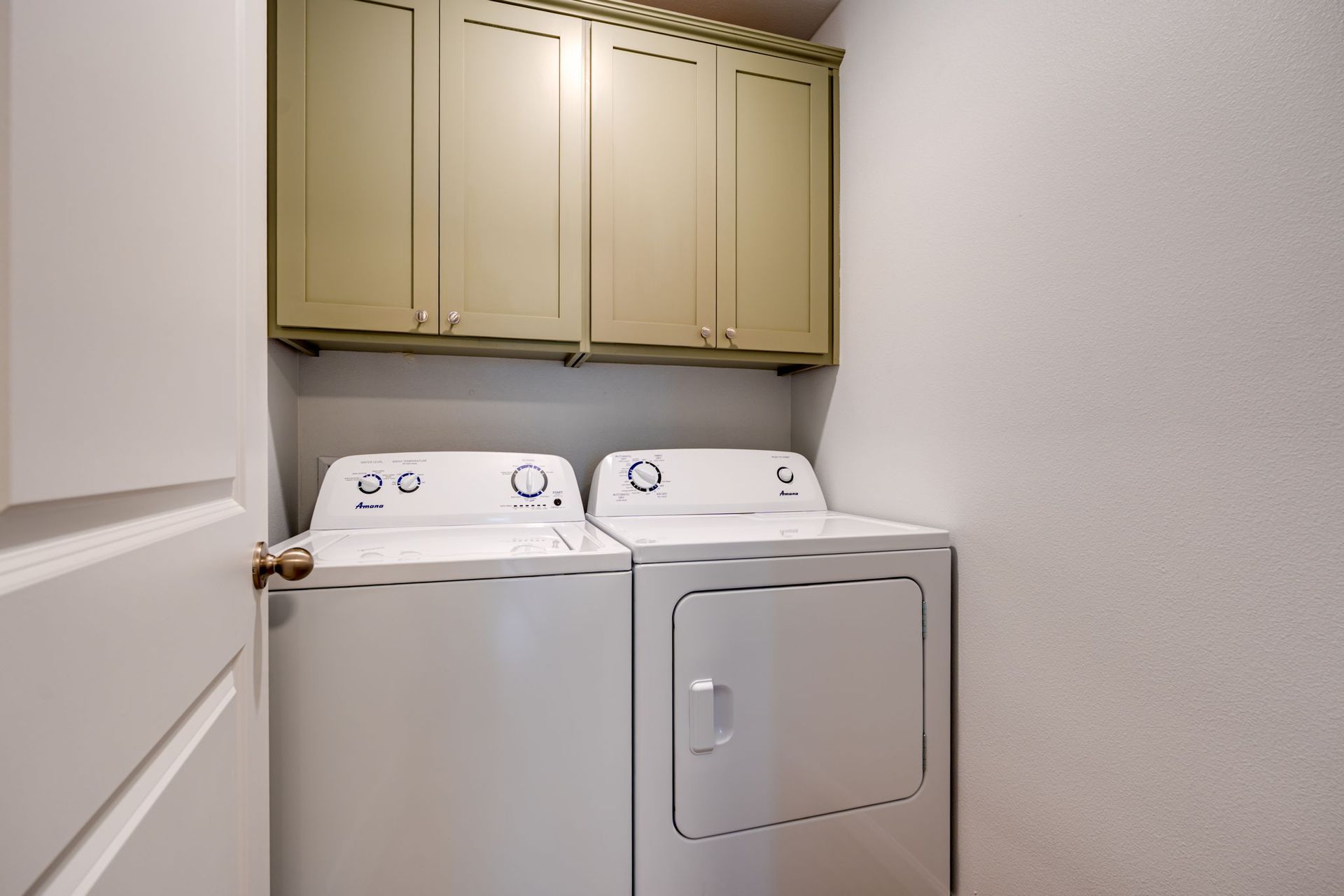 ground floor laundry closet with full size washer and dryer