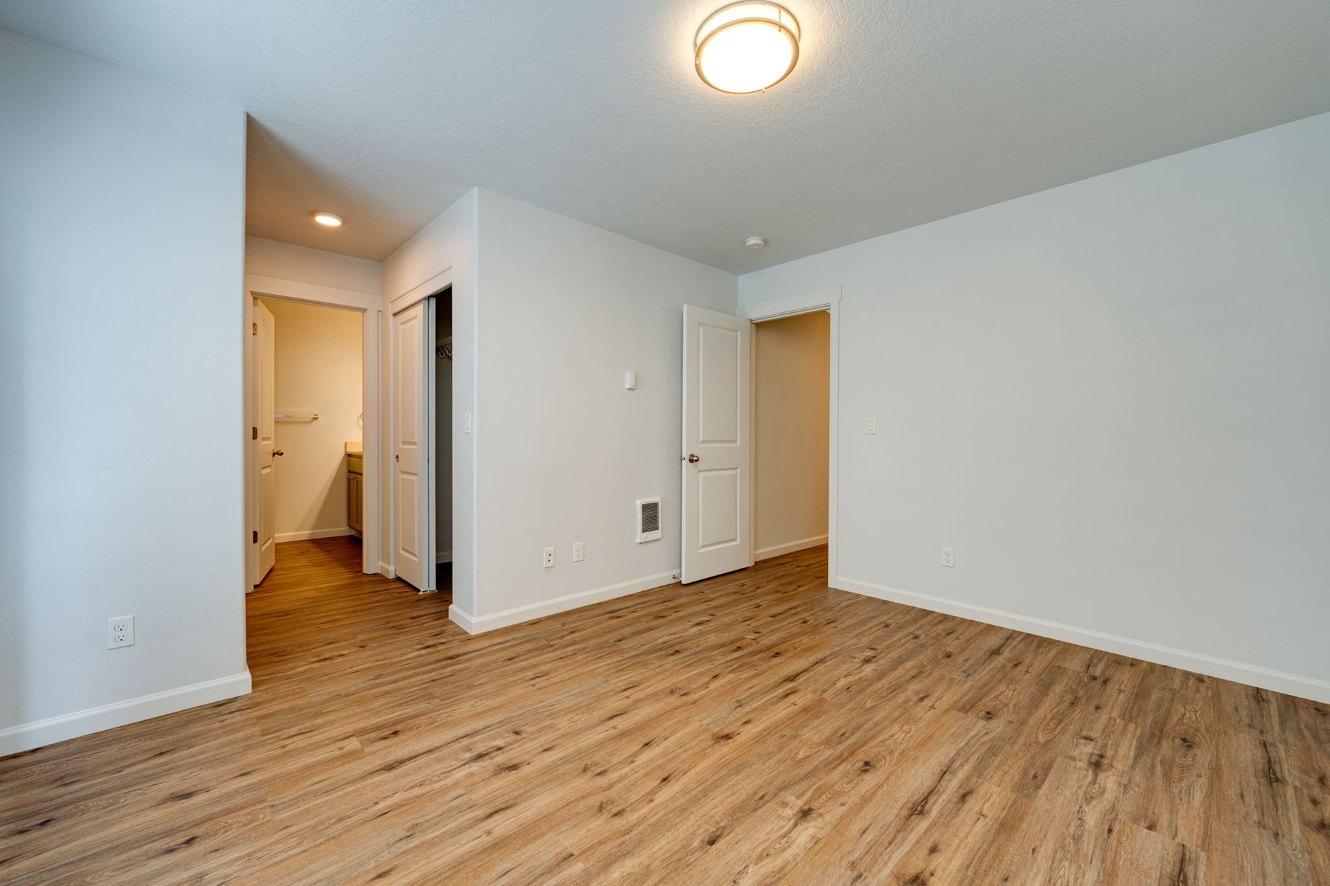 view of bedroom with hallway and main door in the background