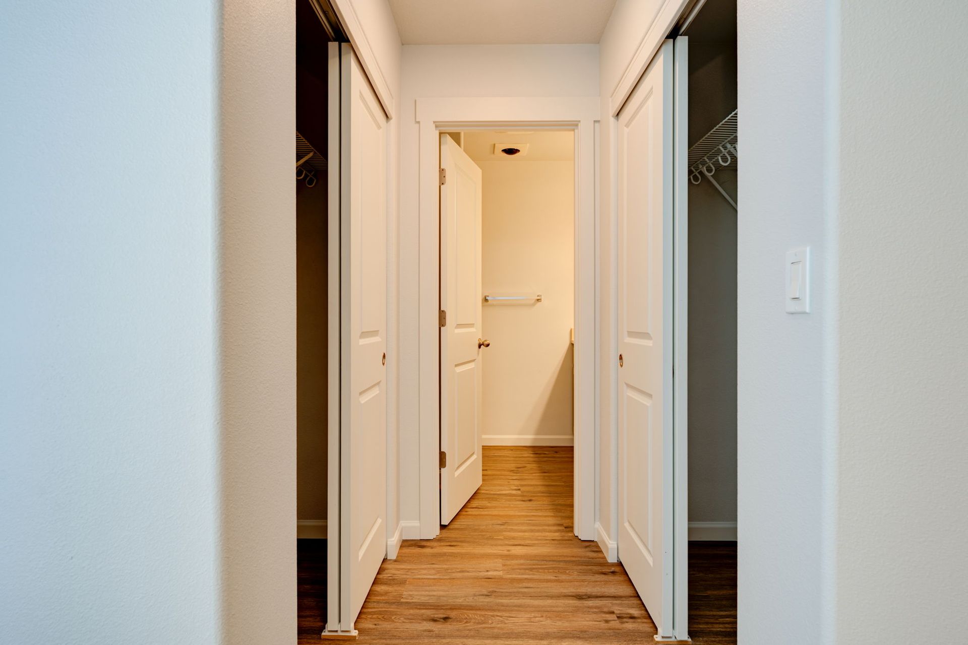 hallway to bathroom in ground floor bedroom. closets on both sides of hallway