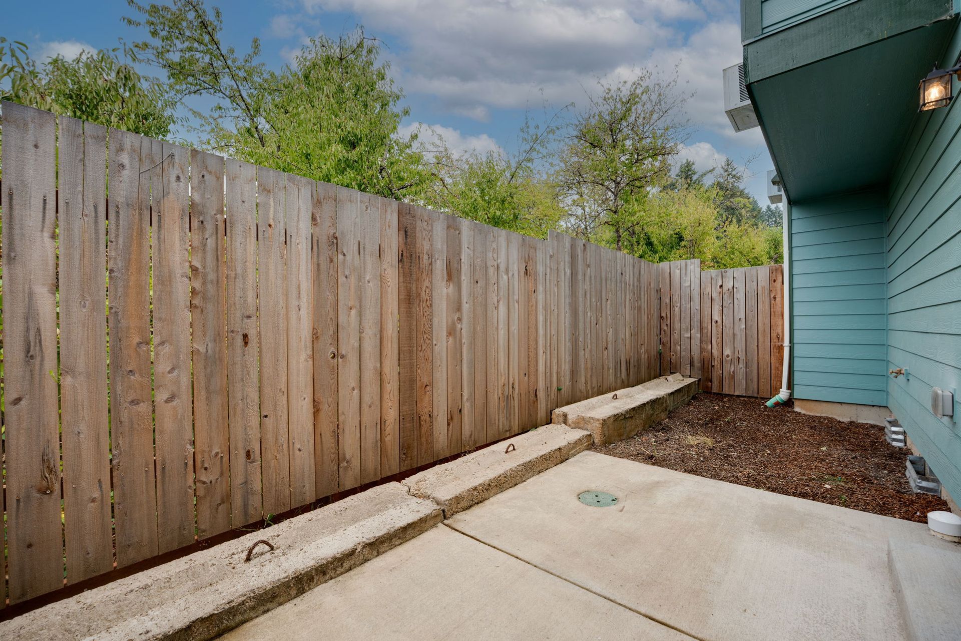 back patio with view of wooden privacy fence