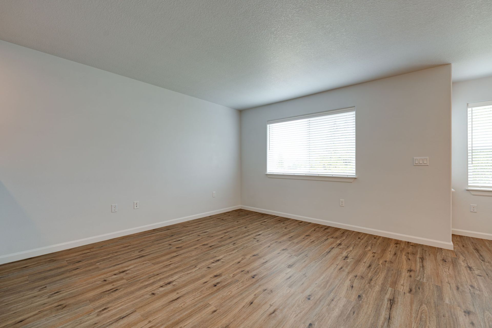 view into living room with large window on the back wall