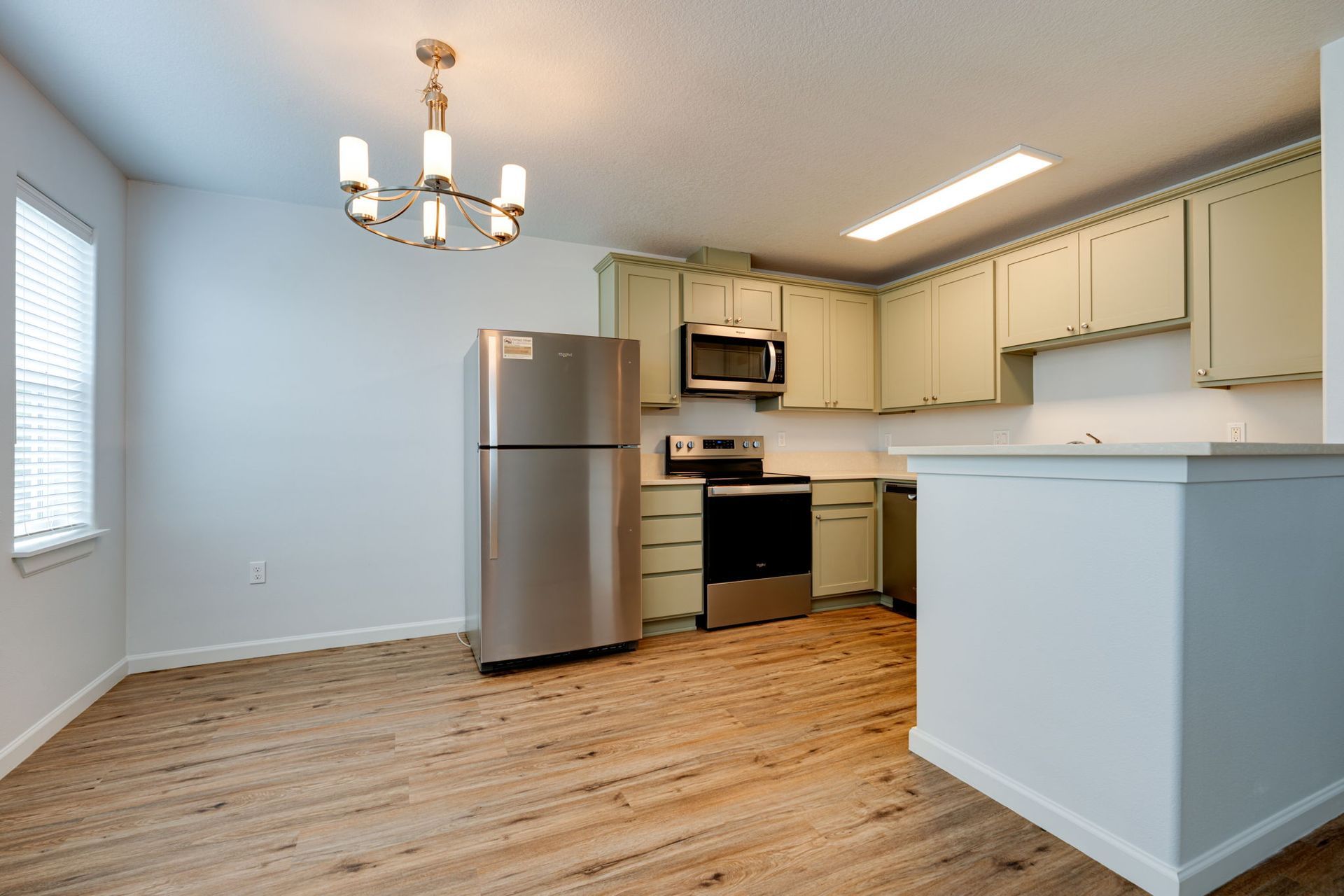 view of unfurnished dining room looking into the kitchen