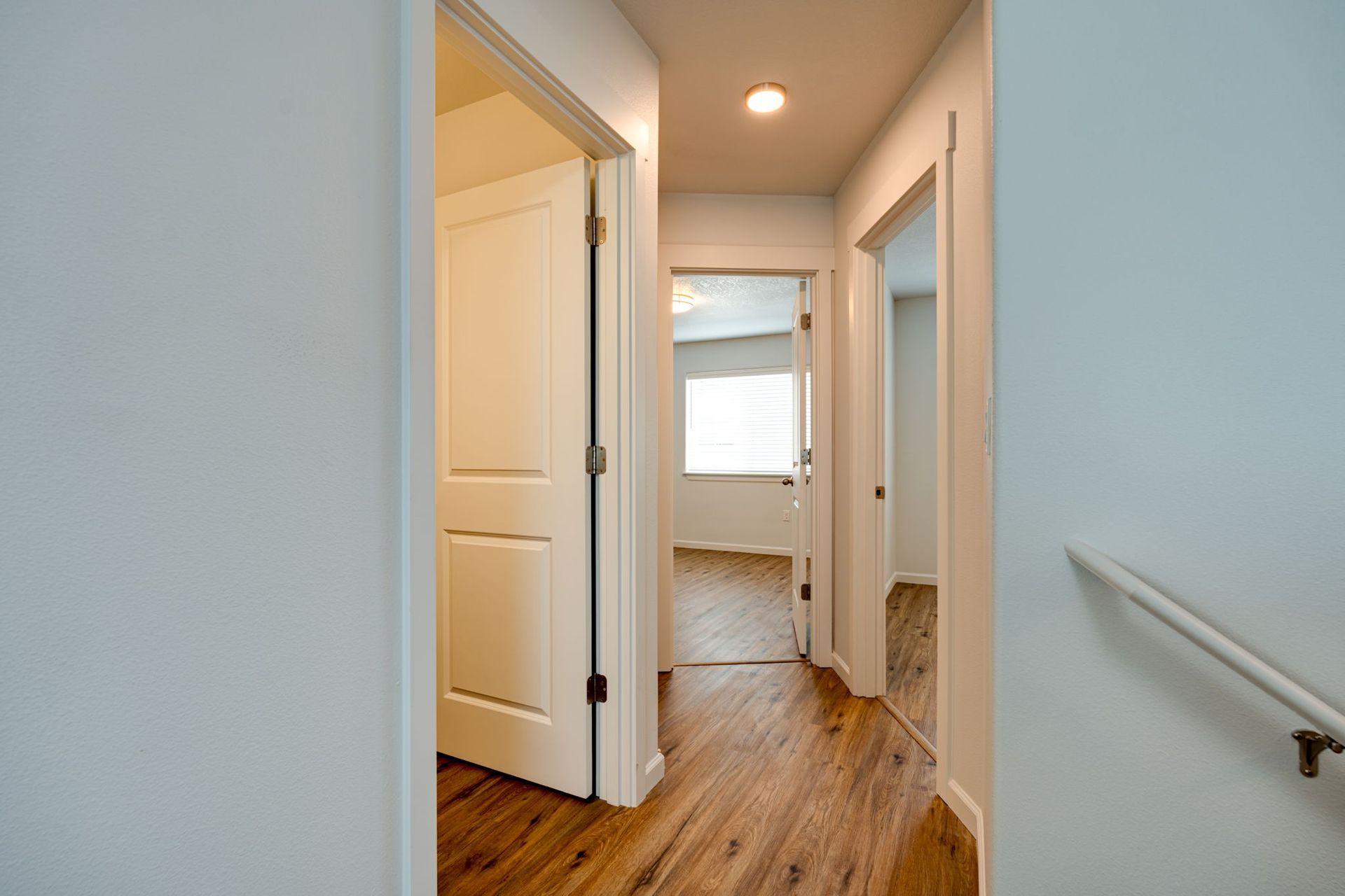 view of hallway into bathroom and upstairs bedrooms