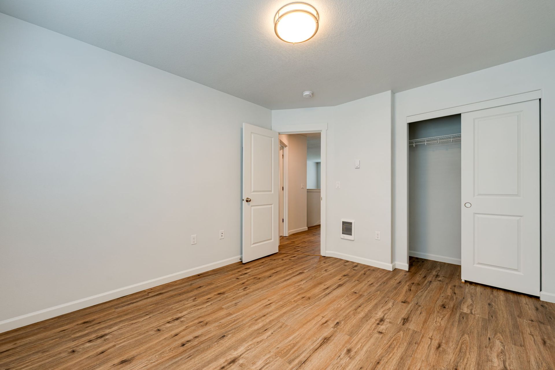 second second-floor bedroom unfurnished with door and closet in the background