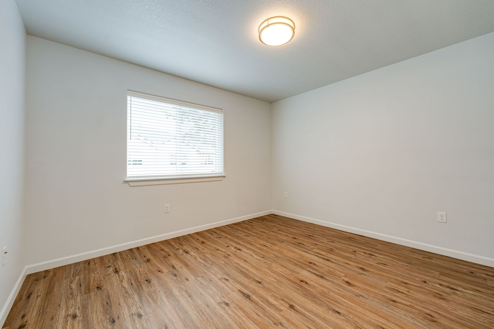 first second-floor bedroom unfurnished with window in the background