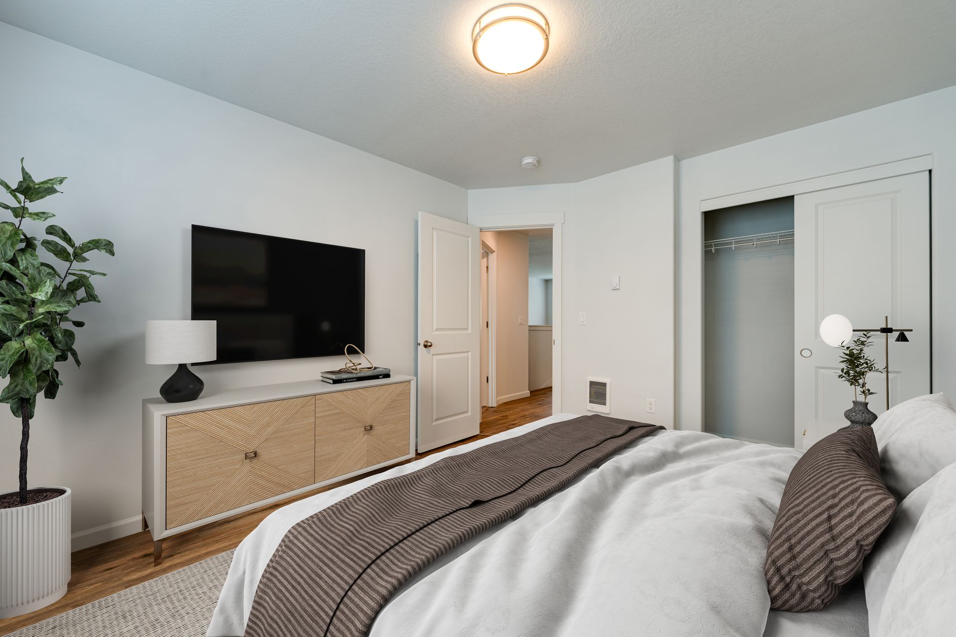 second second-floor bedroom furnished with door and closet in the background