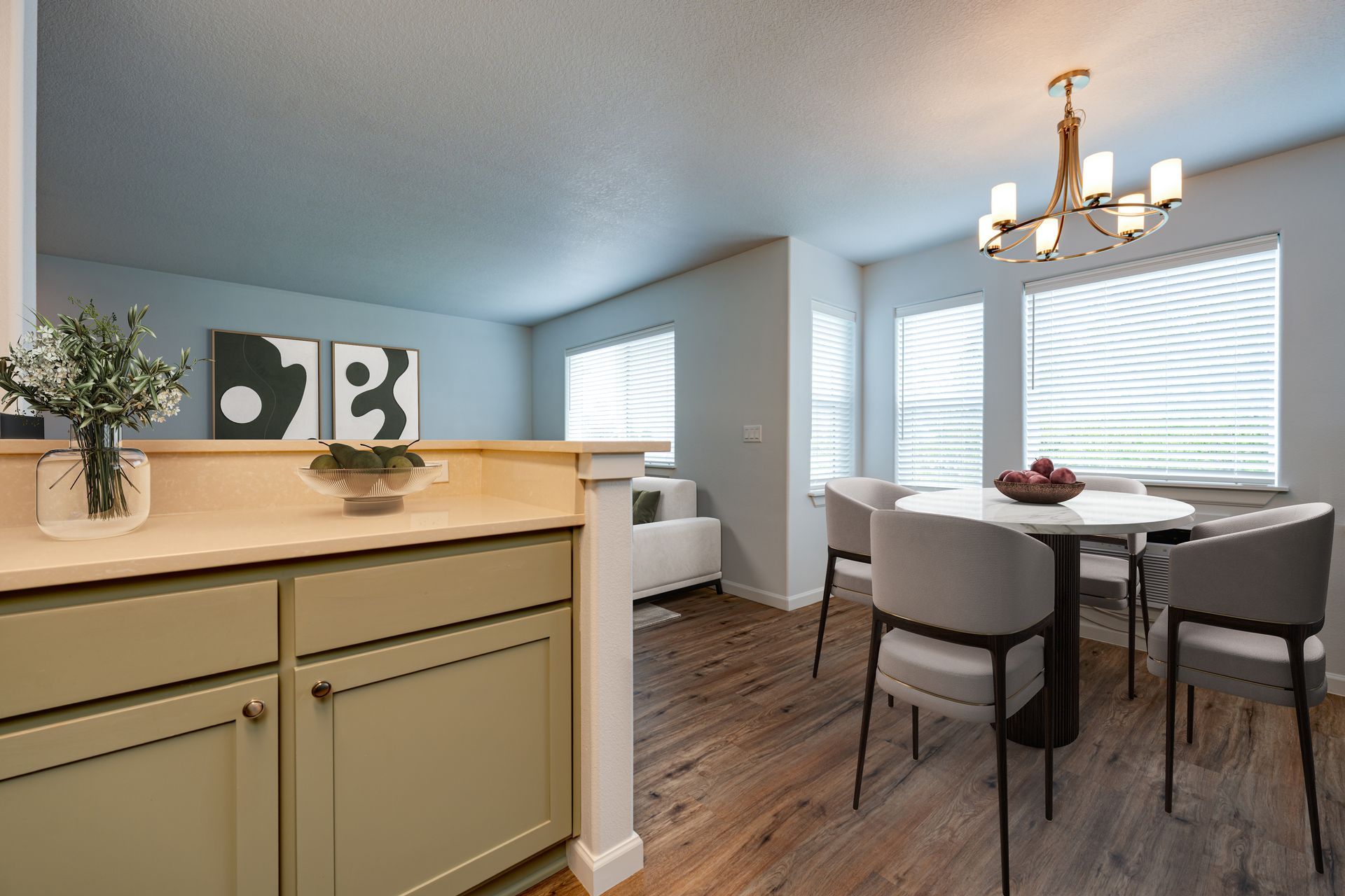 view from kitchen into furnished dining room and living room in the background