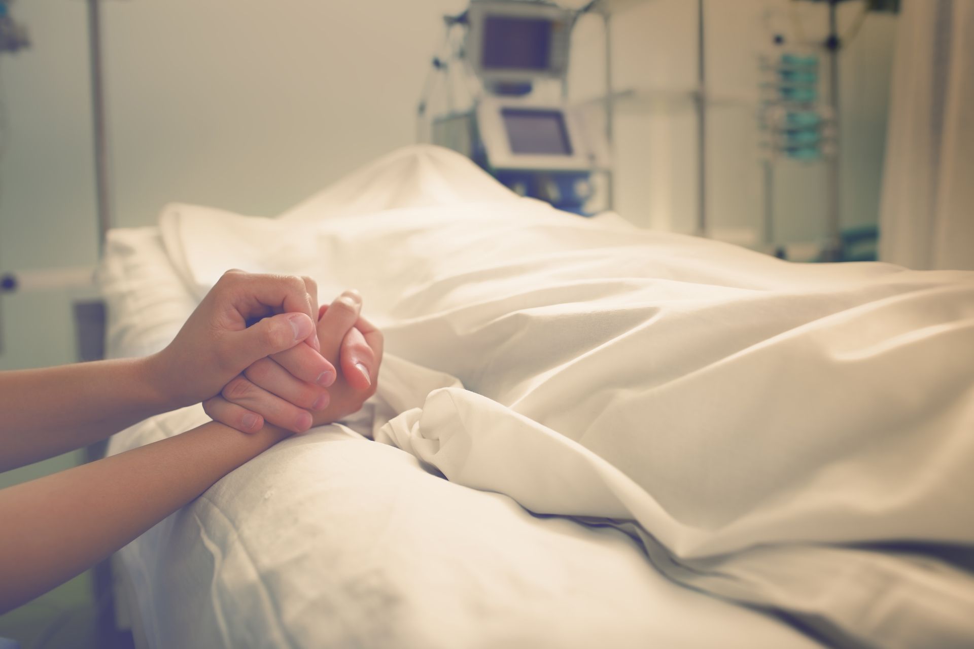 holding hand of someone who died in hospital