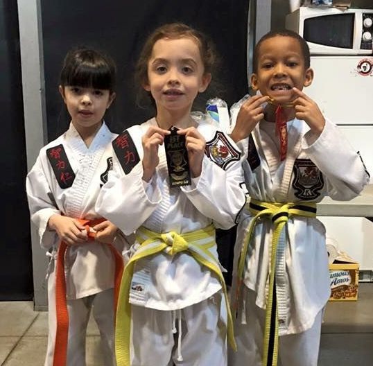 A person is holding a sparkler in their hand in the dark.