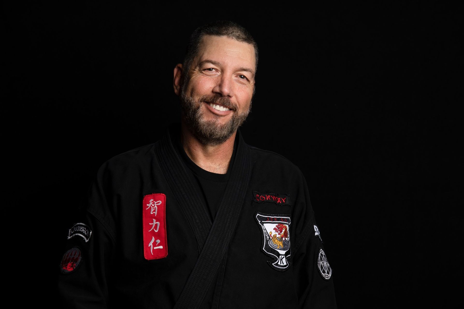 Carlos Machado wearing a white brazilian jiu jitsu uniform with the word machado on it