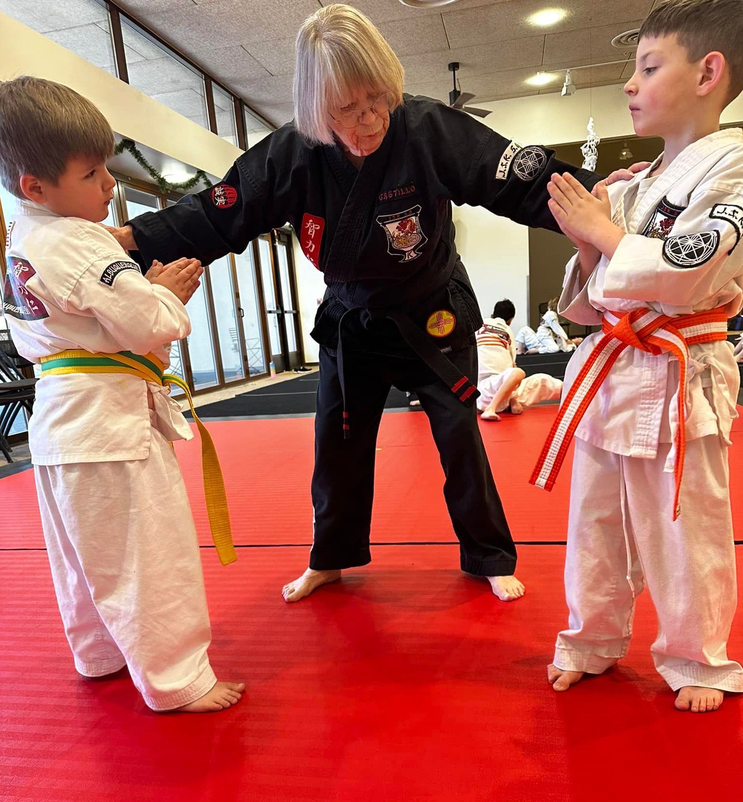 A man and a woman are practicing karate in a gym.
