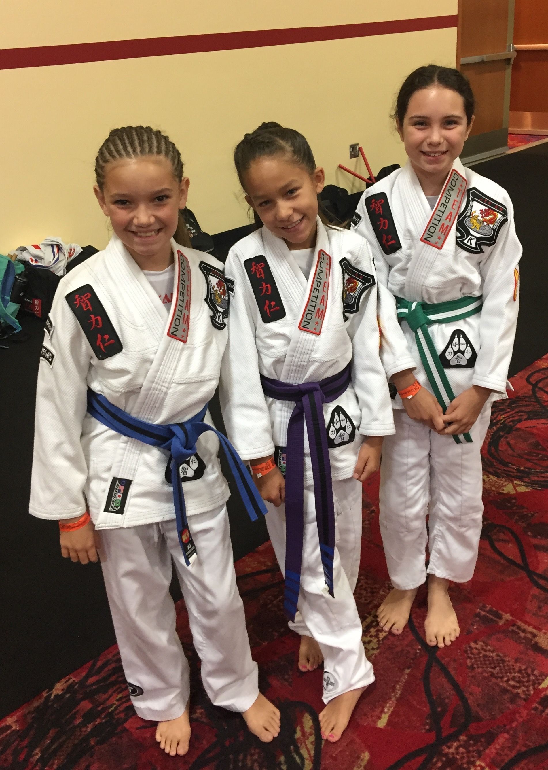 A person is holding a sparkler in their hand in the dark.