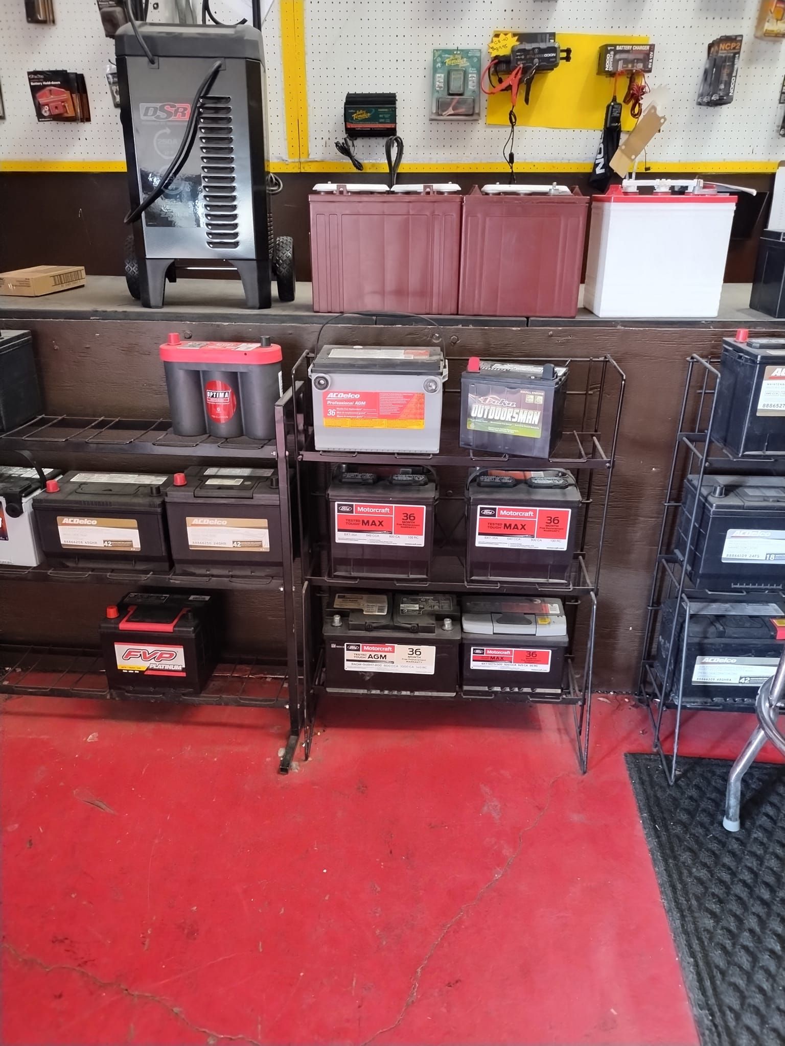 A bunch of batteries are on display in a garage