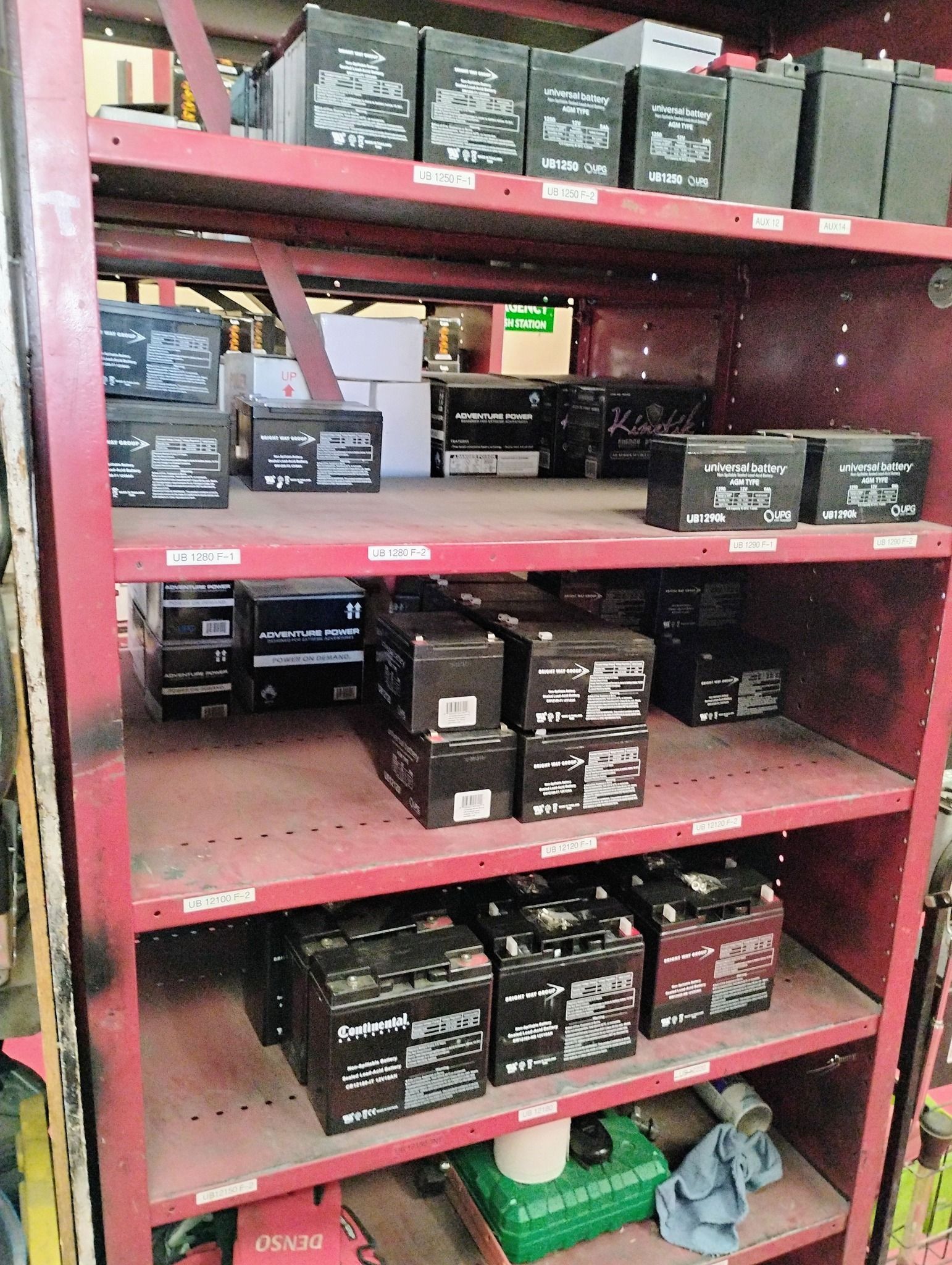 A shelf filled with lots of batteries in a warehouse.