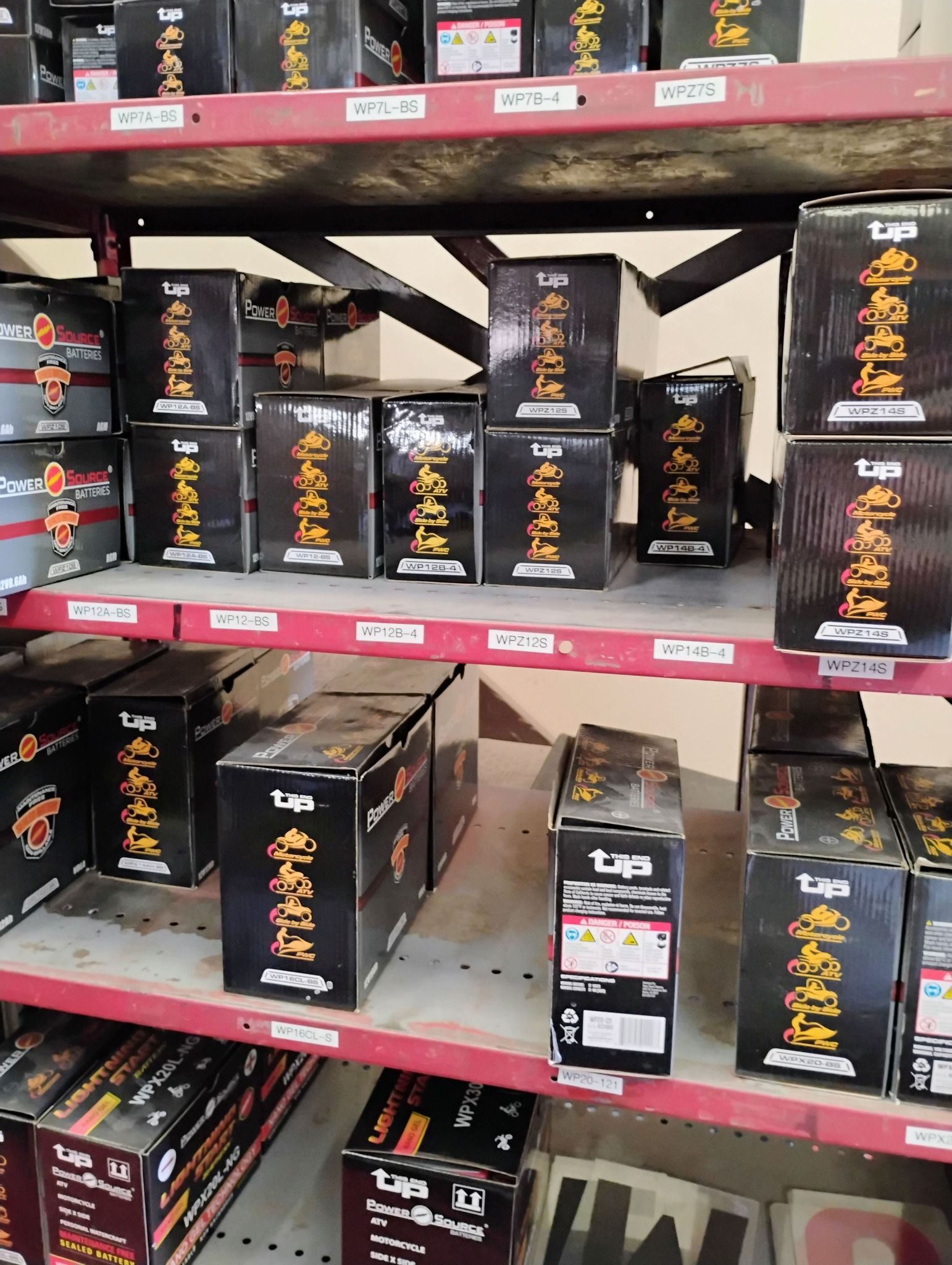 A shelf filled with boxes of fireworks in a store.