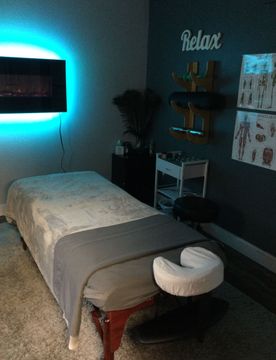 A massage table in a room with a sign that says relax