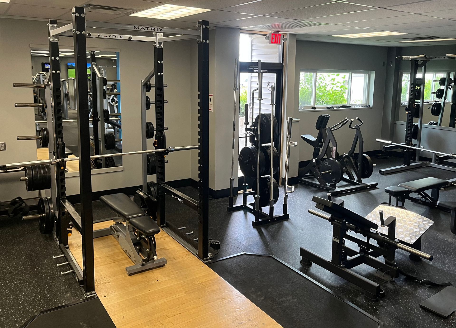 A large gym filled with lots of exercise equipment.
