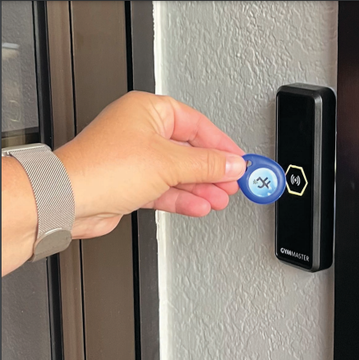 A person is pressing a button with a blue key