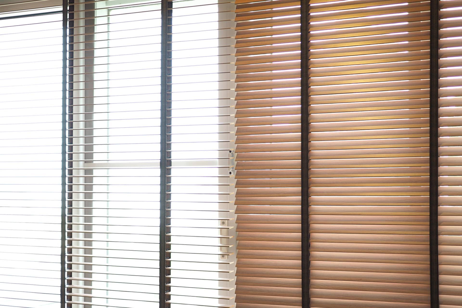 Close up view of window with horizontal blinds. White Roller Blinds or Louver curtains at the glass window