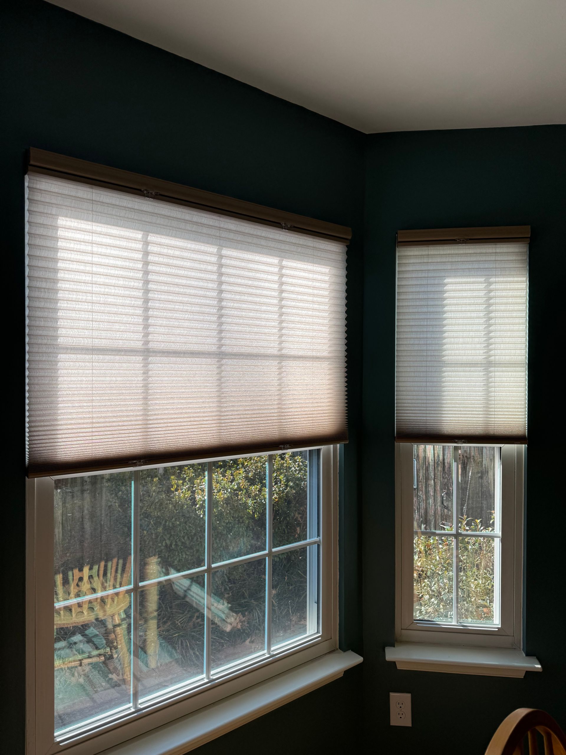 There are two windows in the room with blinds on them.