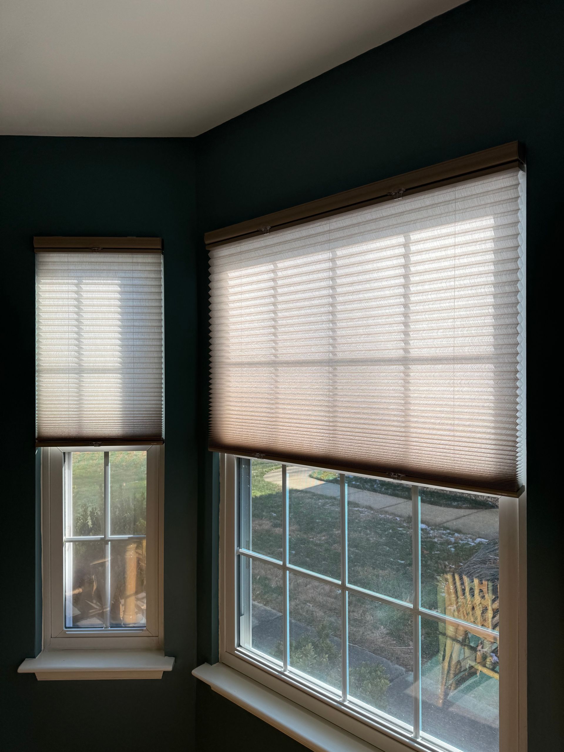 There are two windows in the room with blinds on them.