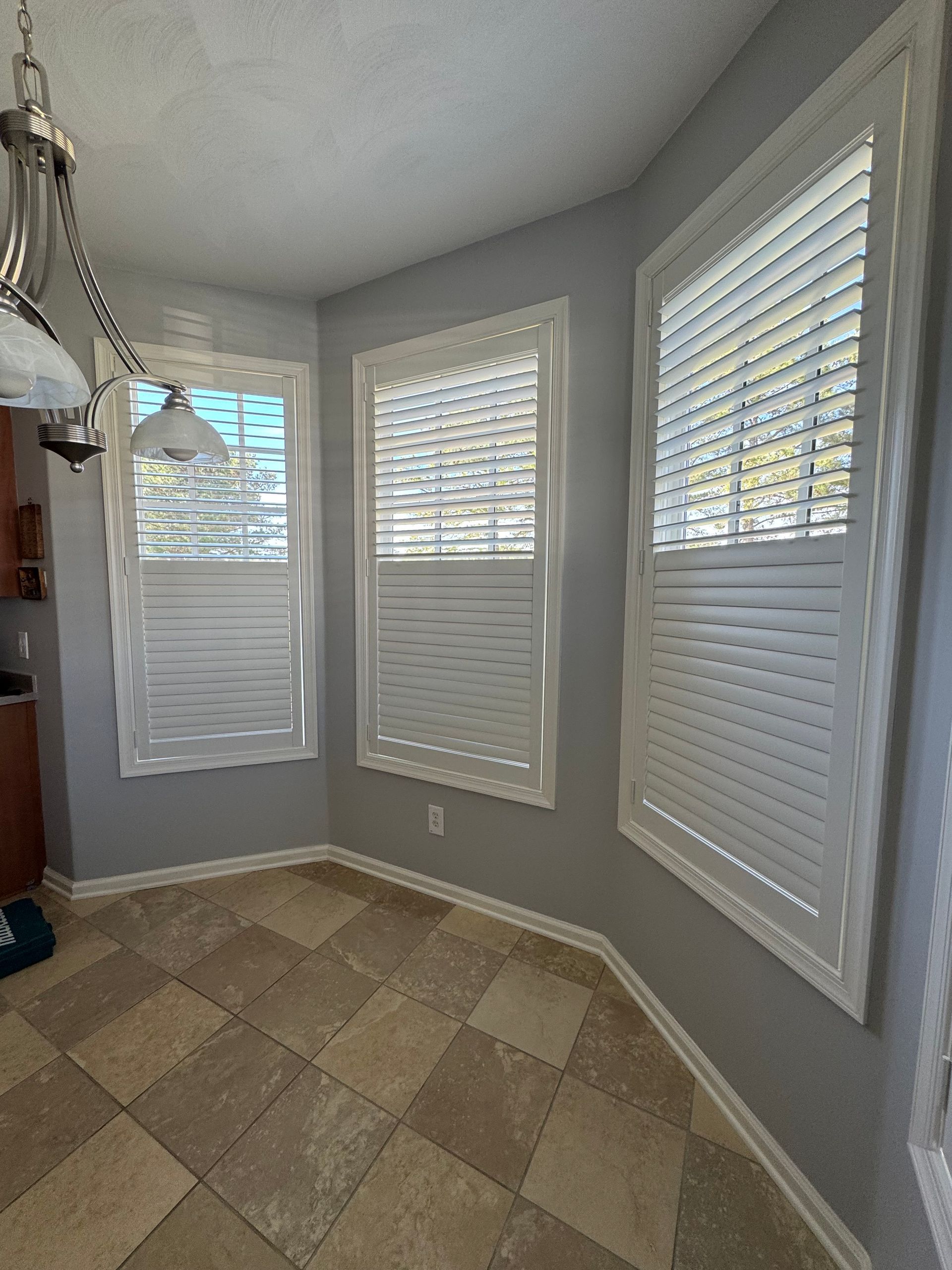A room with a lot of windows and shutters on them
