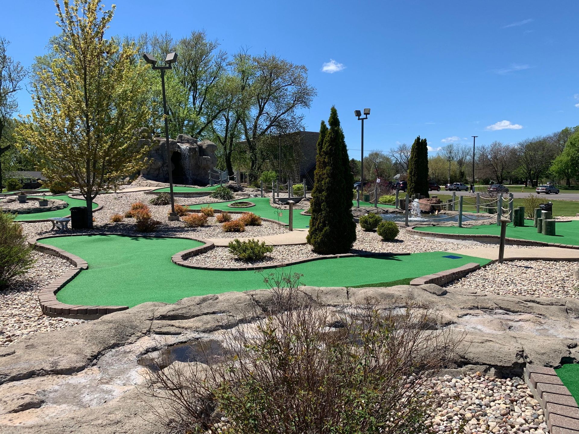 A miniature golf course in a park on a sunny day