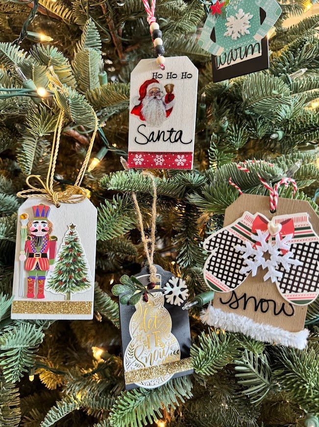 Christmas tree with handmade tag ornaments, including Santa, a snowman, and mittens.