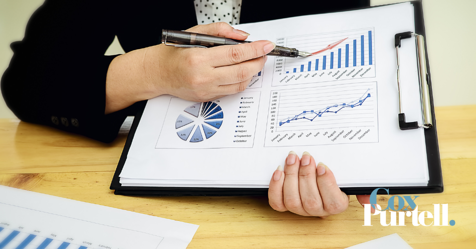 Photo of a person Holding a clipboard of statistics, looking at growth