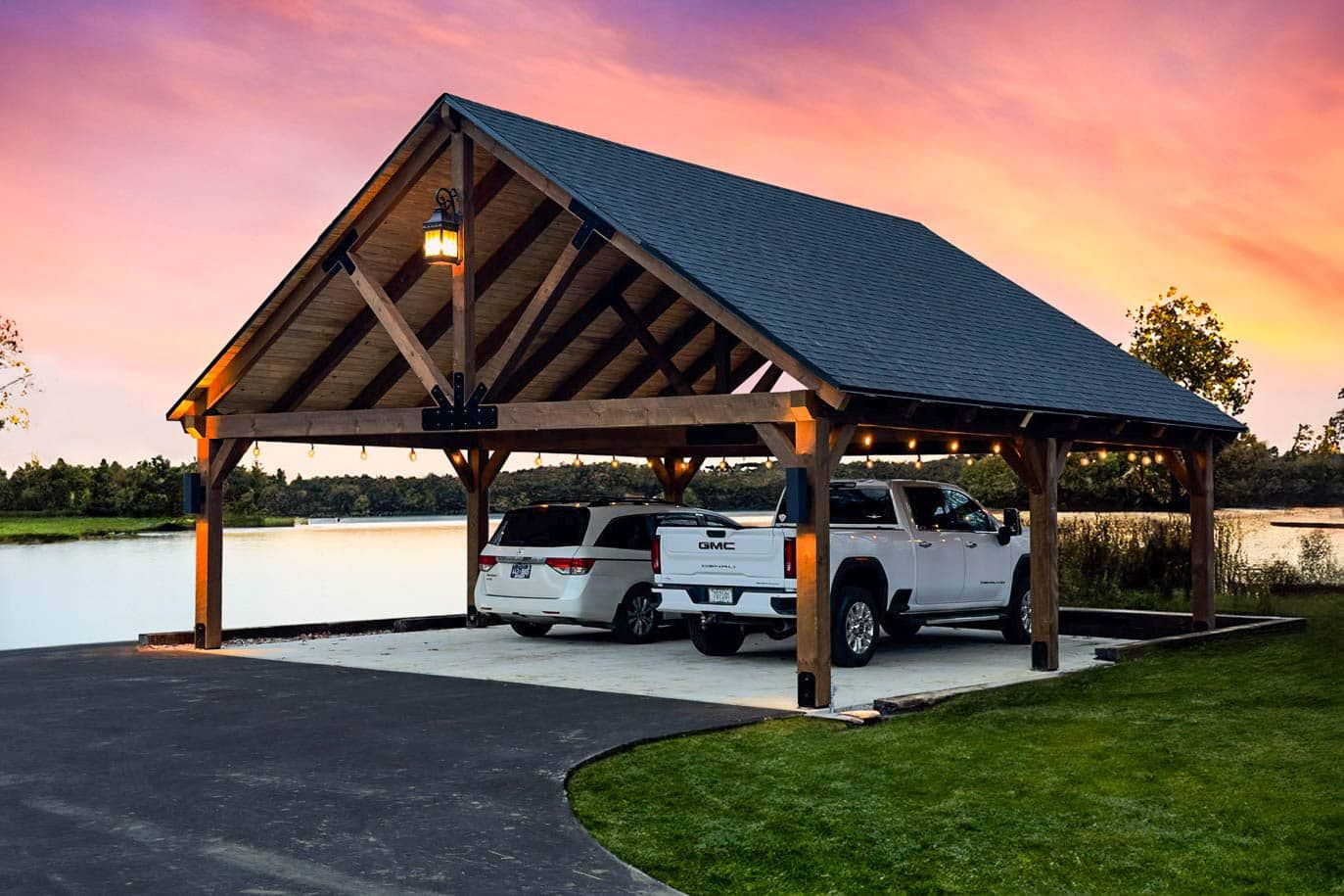 A parking lot with a white roof and trees in the background