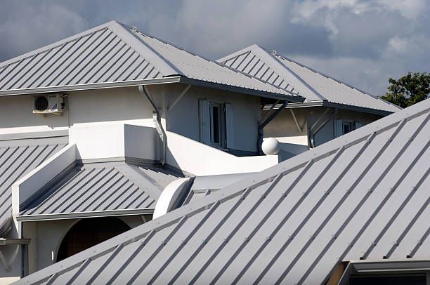 An aerial view of a house under construction with a black roof.