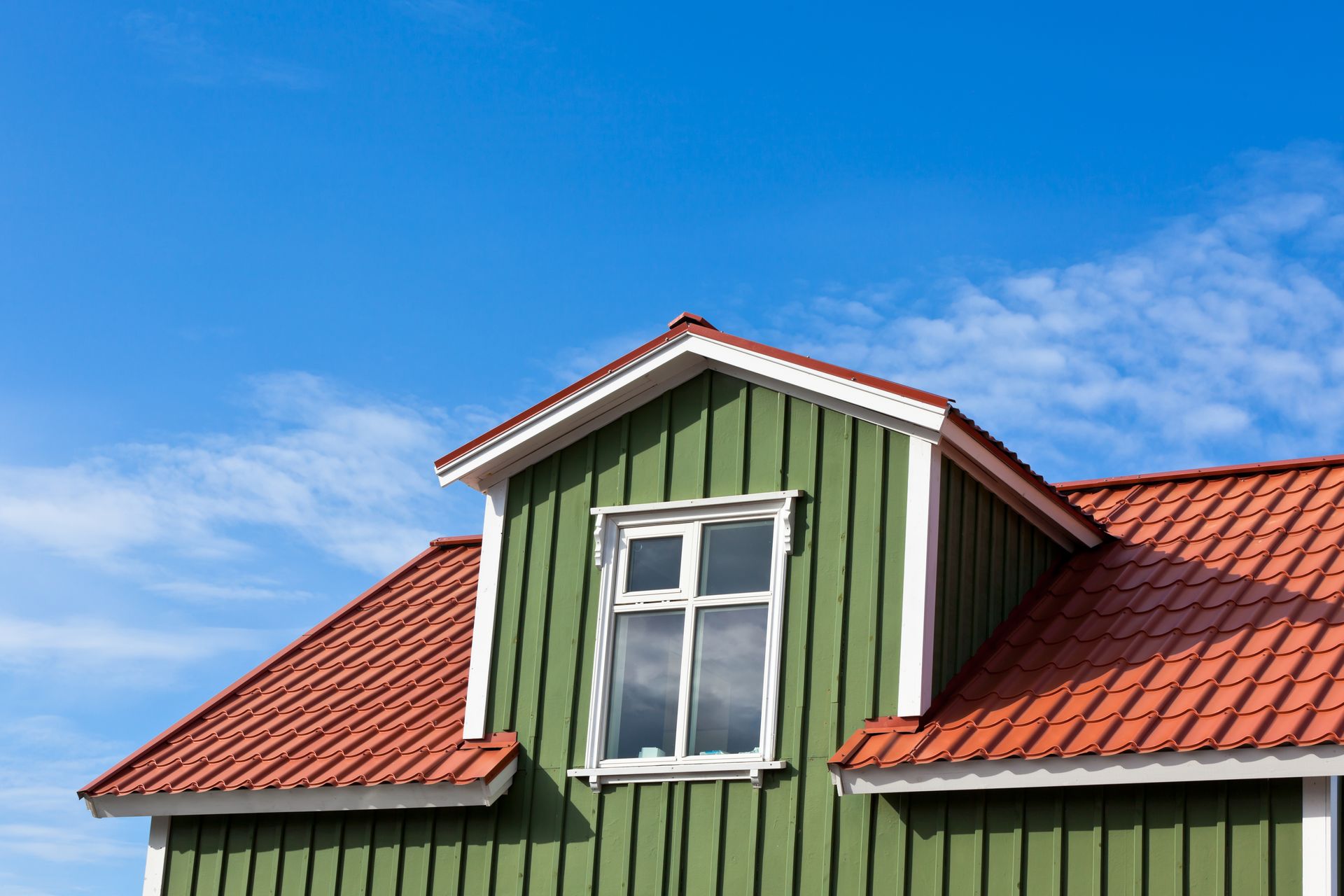 a green house with a red roof and a window new roof install The Amish Roofer (940) 278-8299