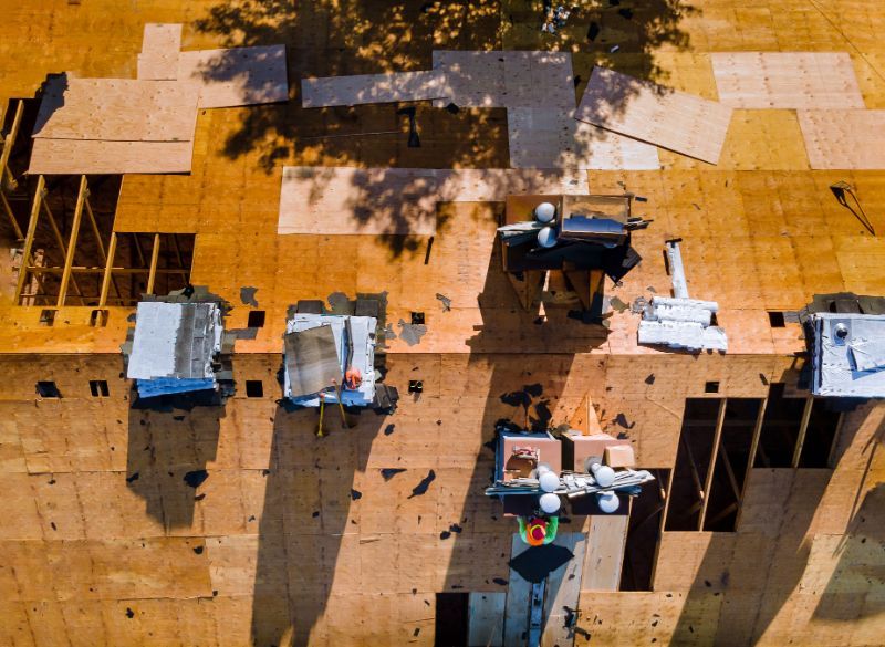an aerial view of a building under construction The Amish Roofer