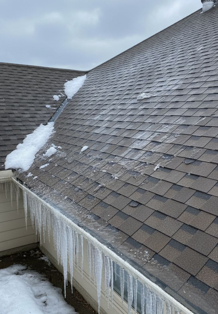 view of a Texas residential roof with ice buildup along the roof edge and eaves - amish roofer, tx