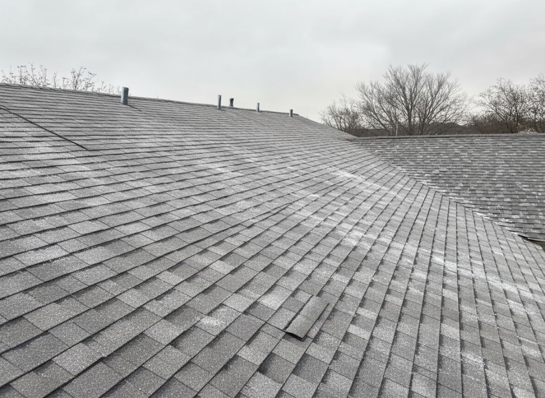 close-up of a Texas residential roof during cold weather, showing slight frost