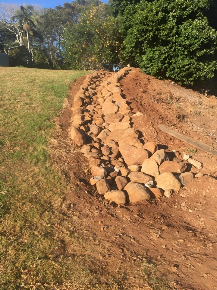 A Pile of Rocks is Sitting on Top of a Dirt Road — Limited Access Excavation In Suffolk Park, NSW