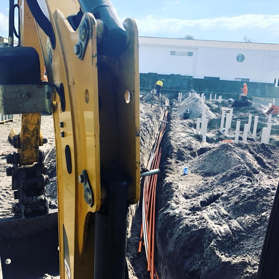 A Yellow Excavator is Working on a Construction Site — Limited Access Excavation In Murwillumbah, NSW