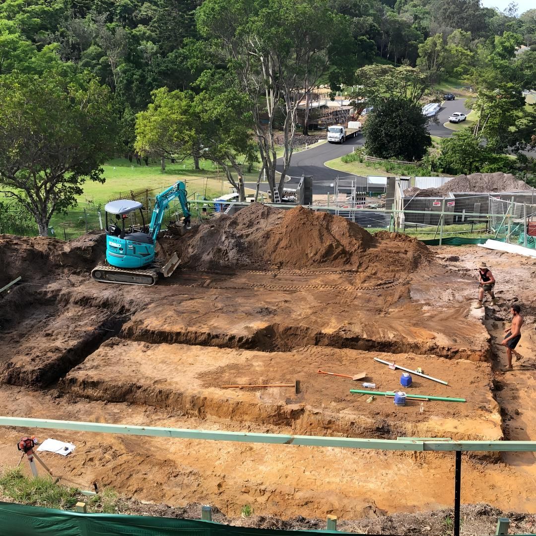 A Construction Site With a Blue Excavator Digging in the Dirt — Limited Access Excavation In Grafton, NSW